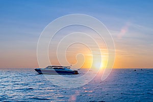 speed boat on the sea with sunset sky background