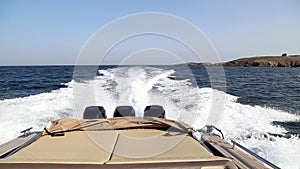 Speed boat with three motors at sea