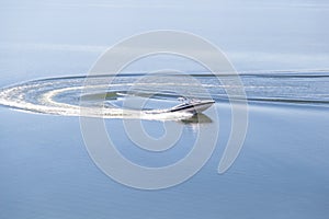 Speed Boat U-turn on a glass lake on a sunny day