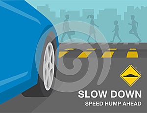 Speed bump on the city road. Slow down, speed hump ahead warning sign meaning. Perspective close-up view of vehicle front tires.