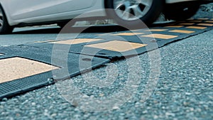 Speed bump. Close-up of car wheels. On the road, a speed bump slows down the movement of cars.