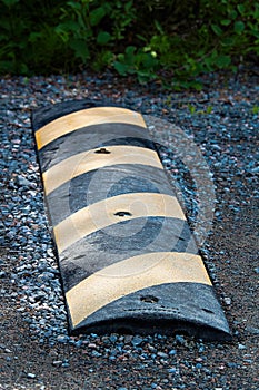 A speed bump on a gravel road