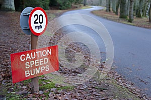 Speed bumps caution sign at road highway in countryside