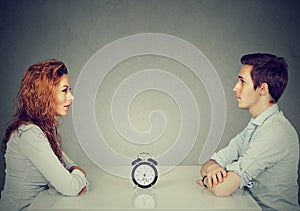 Speed dating. Man woman sitting across from each other at table photo