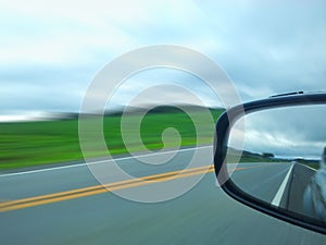 Speed highway on the outside mirror of the car
