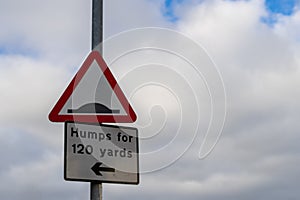 a speed hump warning sign