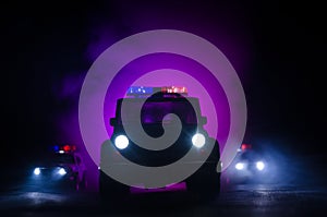 speed lighting of police car in the night on the road. Police cars on road moving with fog. Selective focus. Chase