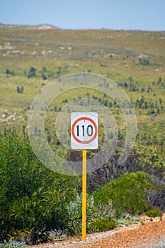 Speed limit 110 kph street sign next to Australian road