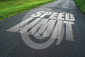 Speed Limit message reminder on asphalt road