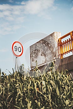 Speed limit road sign near a bridge