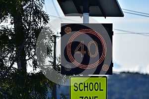 Speed limit and school zone sign