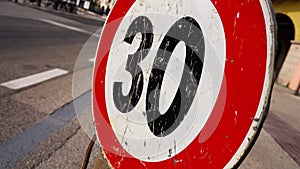 Speed limit sign against bicycle parking lot in downtown