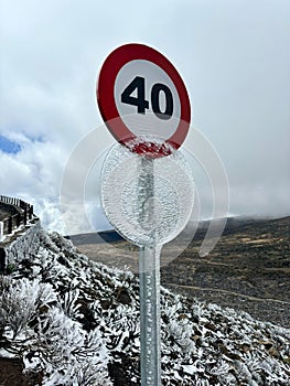 The speed limit sign covered with ice in Teide National Park, Tenerife, Spain