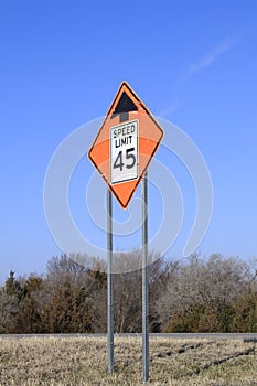 A Speed Limit sign on the Highway for Road construction with blue sky