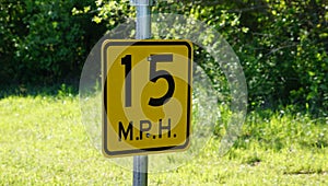 A speed limit sign on a small country road in Texas.