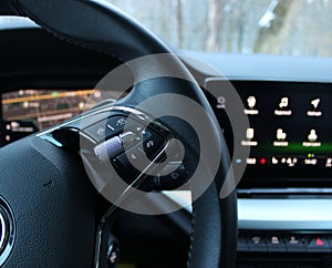 Speed Limiter Mode And Collision Avoidance System Buttons On A Steering Wheel With Blurred Monitor With Menu Icons In Modern Car