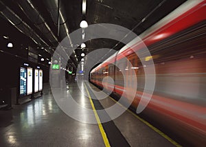 Speed lines from a fast passing train in a dark subway station.