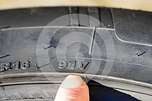 The speed and load index markings on the sidewall of the tire photo