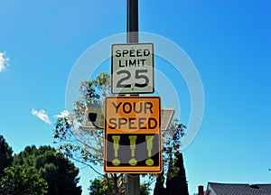 A speed monitoring sign measures excessive speed and displays exclamation points