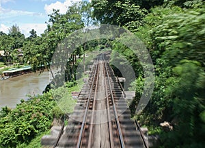 A speed motion of railway bridge alongside River Kwai is a river in western Thailand at Kanchanaburi province.