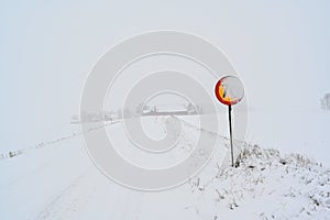speed sign with 70 kph covered in snow