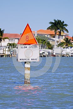 Speed sign and beach house