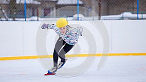 Speed skating young girl on training rink