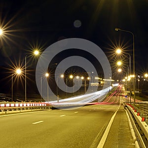 Speed Traffic at Dramatic Sundown Time - light trails on motorway highway at night, long exposure abstract urban background
