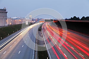 Speed Traffic at Dramatic Sundown Time - light trails on motorway highway at night, long exposure abstract urban background