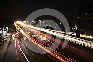 Speed Traffic light trails on highway, long exposure, urban background and dark sky