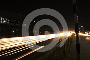 Speed Traffic light trails on highway, long exposure, urban background and dark sky