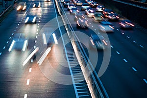 light trails on motorway highway at night, long exposure abstract urban background