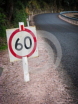 Speed traffic sign on a small mountain road