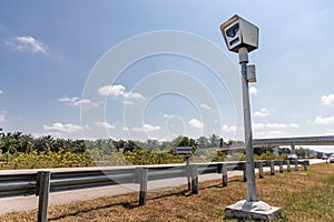 Speed trap surveillance camera along highway to control speeding