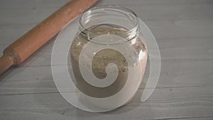 Speed up video for home made spelt starter yeast rising in a glass jar and fermenting of yeast.