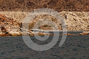 Speedboat driving at Lake Mead with low water line visible in white