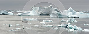 Speedboat and Icebergs in Disko Bay Greenland. photo