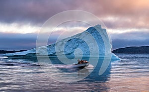 Speedboat and Icebergs in Disko Bay Greenland photo