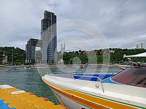 The speedboat is on its way towards the coast of Pattaya City.  Express boat jetty with speedboat.