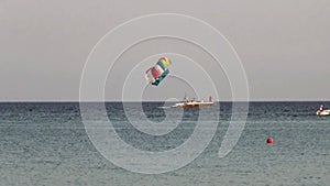 Speedboat with a parachute towed behind at sunset. Parasailing.