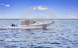 Speedboat sailing in Mediterranean Sea. White inflatable boat crossing Aegean Sea, summer vacation