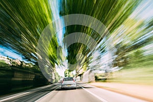 Speeding Car On A Highway, Country Asphalt Road. Motion Blur Bac