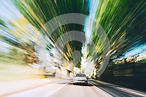 Speeding Car On A Highway, Country Asphalt Road. Motion Blur Background. Dangerous Drive