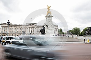 Speeding car at the Victoria Memorial in front of Buckingham Palace in London England