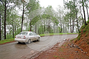 Speeding car on winding roads of the himalayas, In