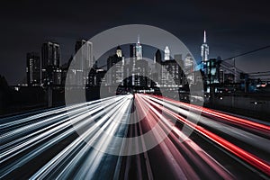 Speeding cars blur against illuminated city skyline backdrop