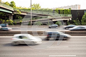 Speeding cars driving on the A4 highway in the suburbs of Paris with motion blur.