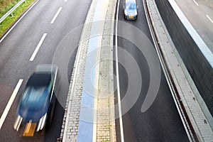 Speeding cars on highway lanes photo