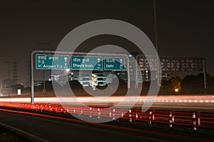 Speeding cars on modern Road infrastructure in Gurgaon, Delhi, India.Artistic long exposure shot at night