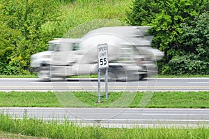 Speeding Concrete Truck Races Past Speed Limit Sign